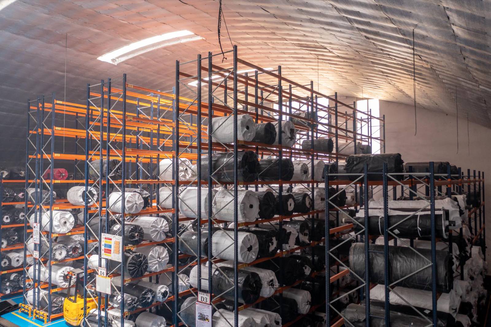 Racked fabric rolls in the finished-goods store